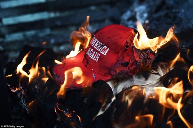 burning MAGA hat